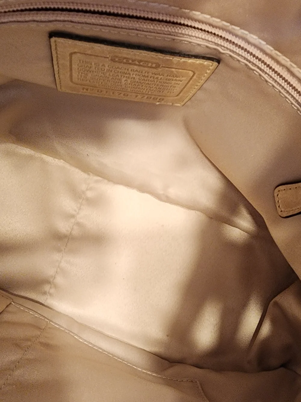 2011 Coach Poppy Push Lock Satchel features a beige leather exterior